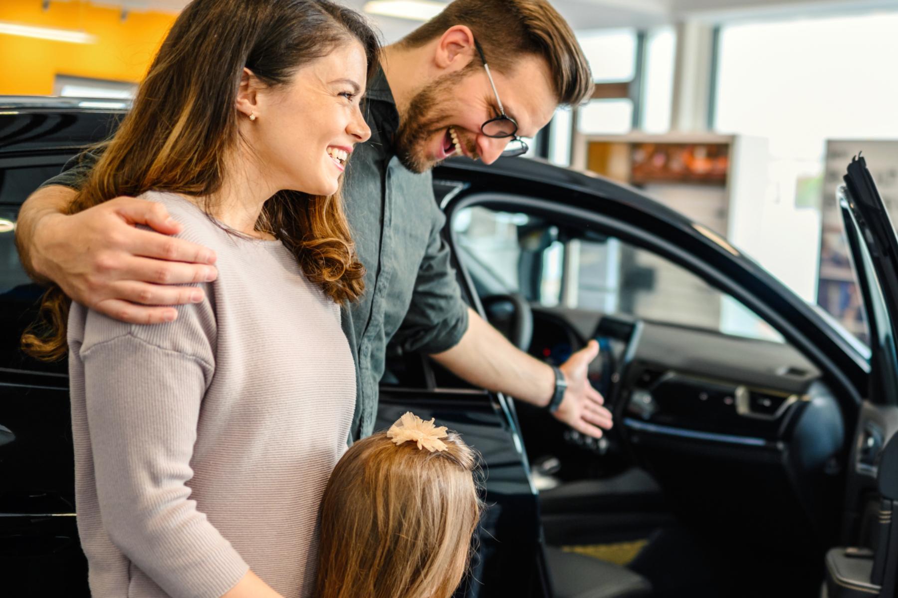 Happy family inspecting a new car – personal auto insurance protection